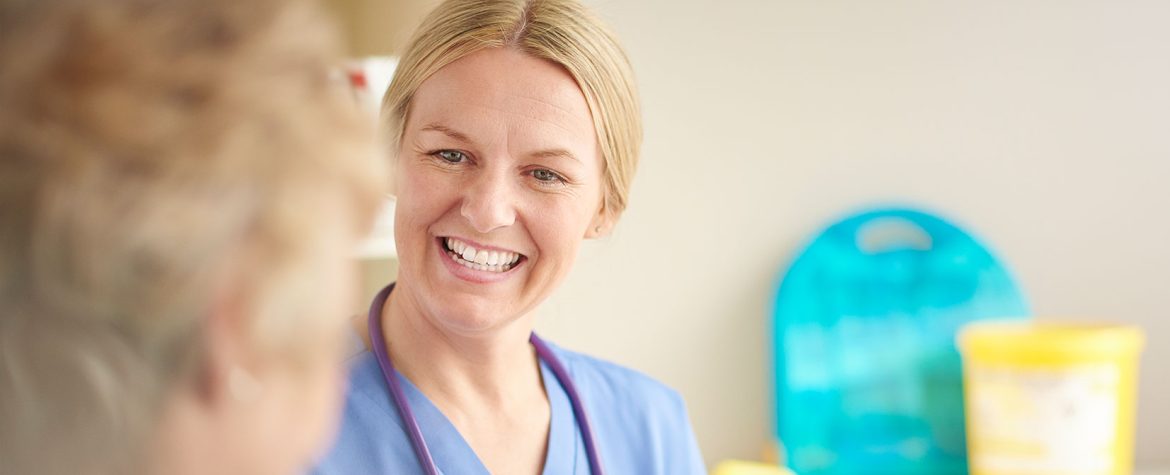 Photograph of a smiling nurse.