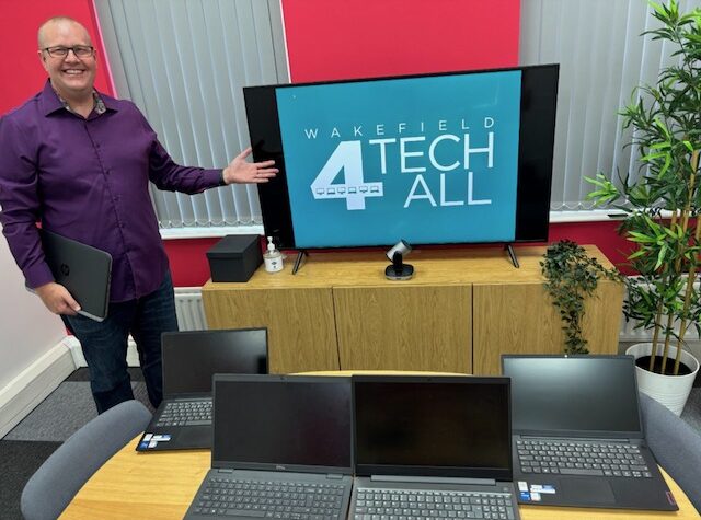 Wakefield Tech 4 All office with laptops and a TV screen.