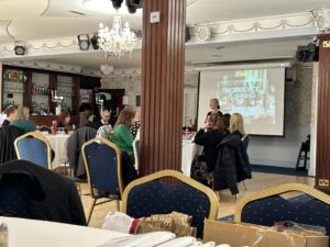 A room of people watching a presentation