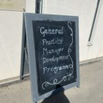 A sign with the words Practice Managers Development Programme written on it