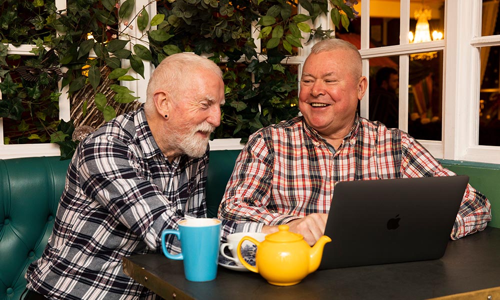 Two people looking at a laptop.