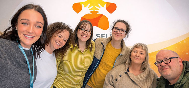 A group of colleagues smiling for a photo.