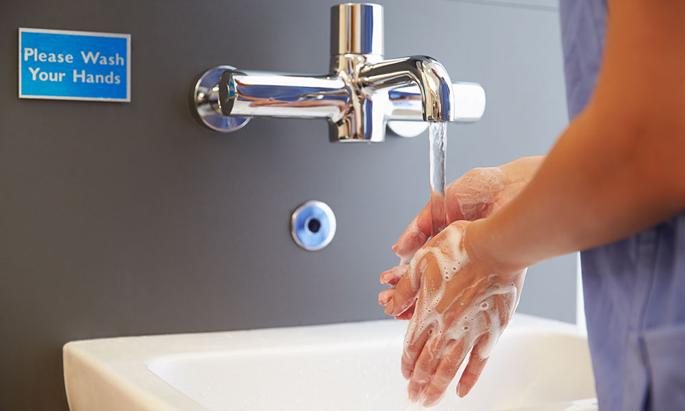 A nurse washing her hands.