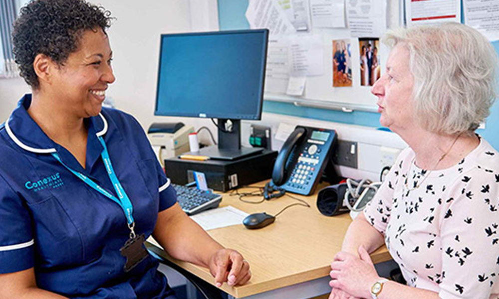 A nurse talking to a patient.